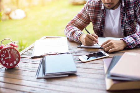 Image of document with charts on background of male and female working , business conceptの写真素材
