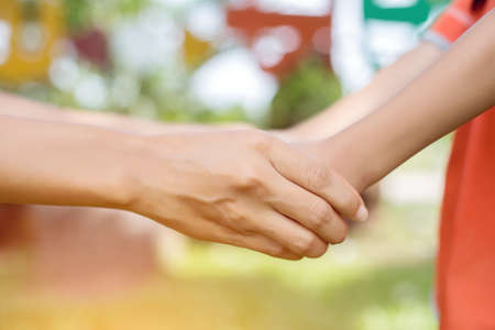 Happy couple holding hands in the sunsetの写真素材