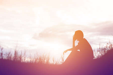 Sad and depressed woman sitting aloneの写真素材