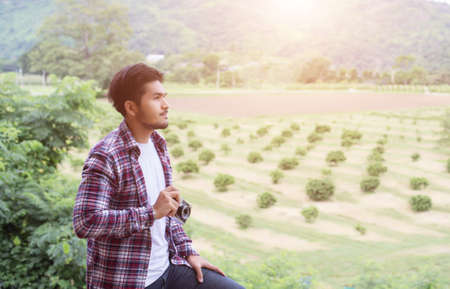 handsome hipster bearded man with cup of morning coffee walking in park.の写真素材