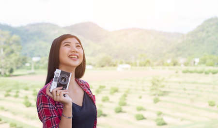Young hipster woman photographer holding a vintage camera.の写真素材