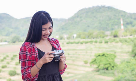 Young hipster woman photographer holding a vintage camera.の写真素材