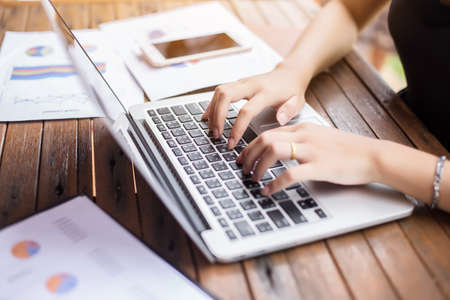 Business team working on laptop, while sitting at office. Business people.の写真素材