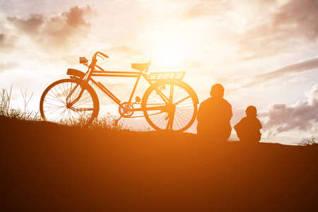 Biker family silhouette father and sonの写真素材