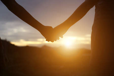 young couple holding hands. In Nature sunriseの写真素材