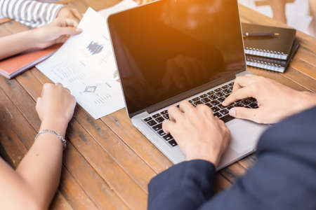Business team working on laptop, while sitting at office. Business people.の写真素材