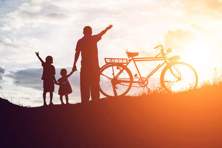 Biker family silhouette father and sonの写真素材