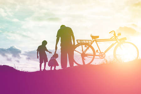 Biker family silhouette father and sonの写真素材