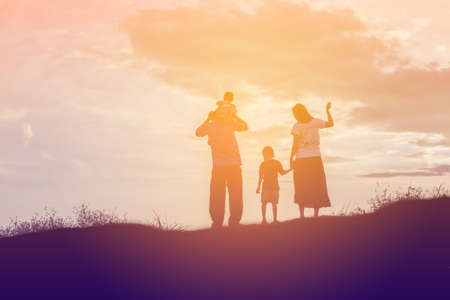 Happy family dancing on the road in the sunset time. Evening party on the natureの写真素材