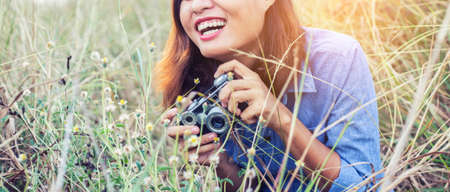 Vintage of beautiful women photography standing hand holding retro camera with sunrise,dream soft...
