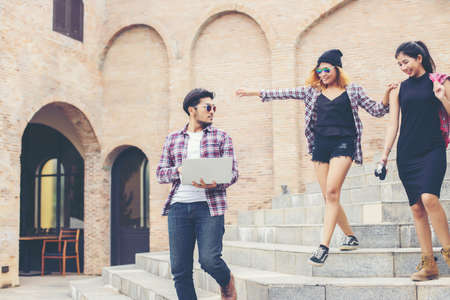 Summer holidays and hipster teenagers group traveling together in urban town having fun and happy...