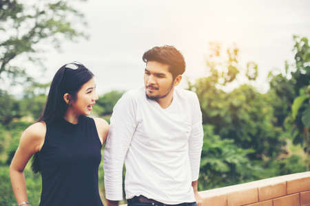 Young handsome boyfriend hugging his girlfriend, she was sad and upset.の写真素材