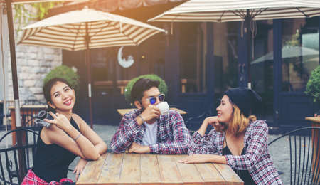 Group of young hipster sitting in a cafe,Young cheerful friends having fun while take time together, Holiday freedom enjoy.の写真素材