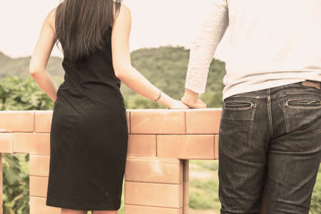 Young handsome boyfriend hugging his girlfriend, she was sad and upset.の写真素材