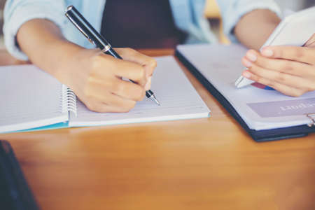 Hand writing in notebook for backgroundの写真素材