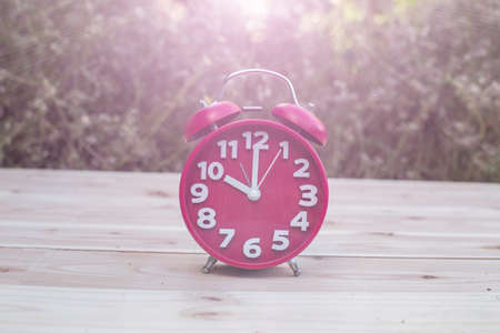 alarm clock with abstract nature bokeh blur background.の写真素材