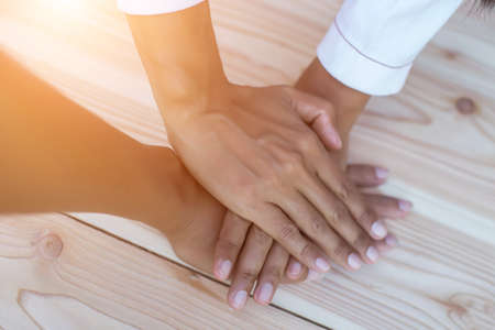 Hands clasped together on tableの写真素材