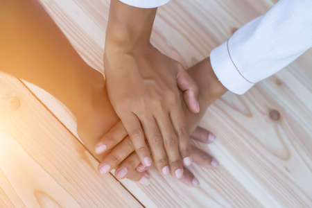 Hands clasped together on tableの写真素材