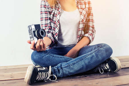 Young beautiful hipster woman with an old retro camera.の写真素材