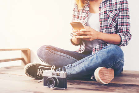 Young beautiful hipster woman with an old retro camera.の写真素材