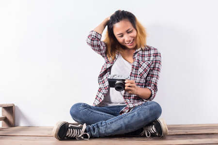 Young beautiful hipster woman with an old retro camera.