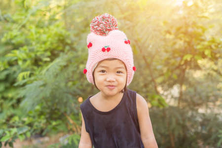 Little cute asian girl standing among the purple flower field sunshine day. Freedom enjoying with nature.の写真素材