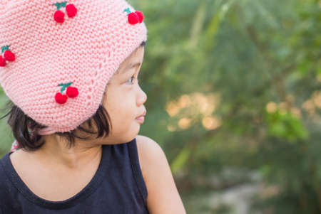 Little cute asian girl standing among the purple flower field sunshine day. Freedom enjoying with nature.の写真素材