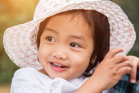 Little girl watering tree with watering potの写真素材
