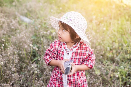 little girl photographs flower outdoorの写真素材