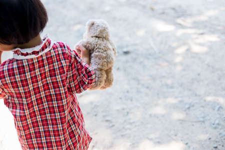Girl embracing teddy bearの写真素材