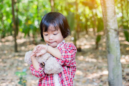 Girl embracing teddy bearの写真素材