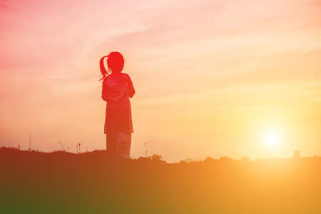 kid silhouette,Moments of the child's joy. On the Nature sunsetの写真素材