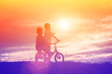 two little boys bike silhouetteの写真素材