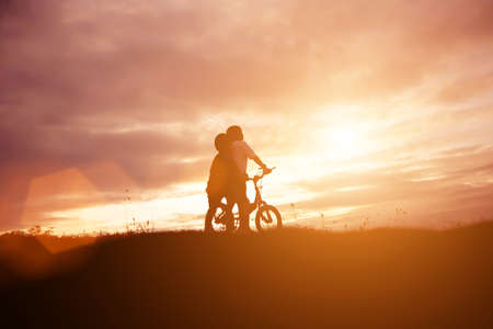 two little boys bike silhouetteの写真素材