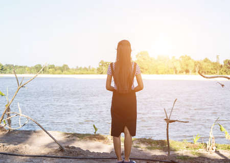 Silhouette of woman praying over beautiful sky background