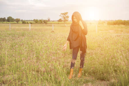 Silhouette of woman praying over beautiful sky backgroundの写真素材