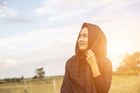 Silhouette of woman praying over beautiful sky backgroundの写真素材