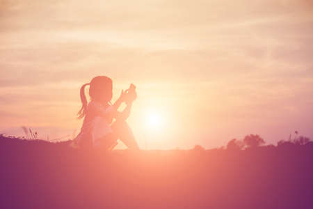 kid silhouette,Moments of the child's joy. On the Nature sunsetの写真素材