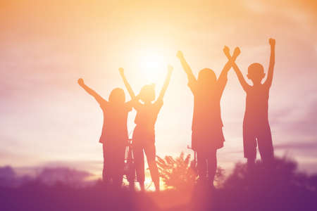 silhouette of a happy children and happy time sunsetの写真素材