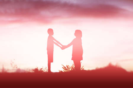 silhouette of a happy children and happy time sunsetの写真素材