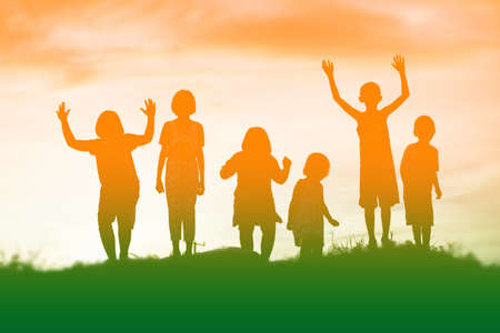 silhouette of a happy children and happy time sunsetの写真素材