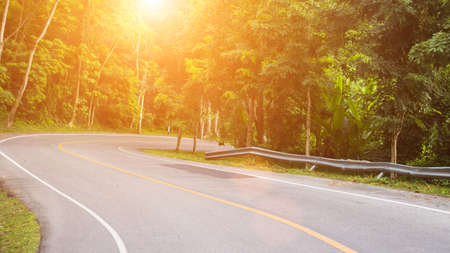 Sun in horizon over asphalt roadの写真素材