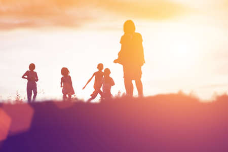 silhouette of a happy children and happy time sunsetの写真素材