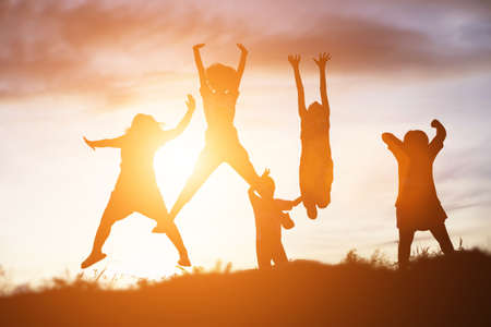 silhouette of a happy children and happy time sunsetの写真素材