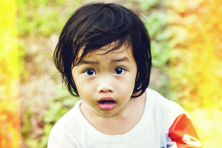 Happy little girl in gardenの写真素材