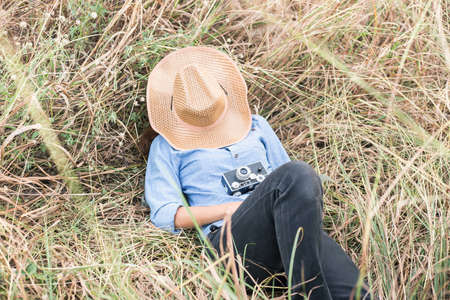 Teenage girl lying down in the grassの写真素材