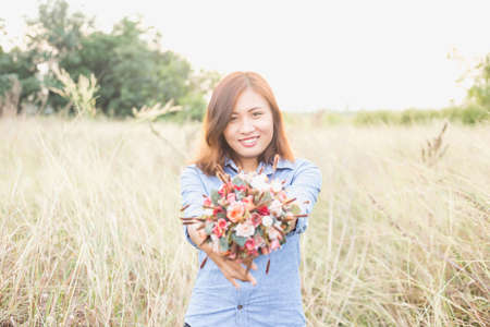 Freshly cut flowers in woman's handの写真素材