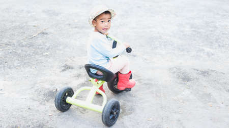 A cute kid riding a bicycle