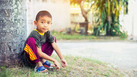 Sad boy sits aloneの写真素材