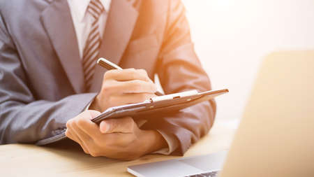 Business team working on laptop, while sitting at office. Business people. の写真素材